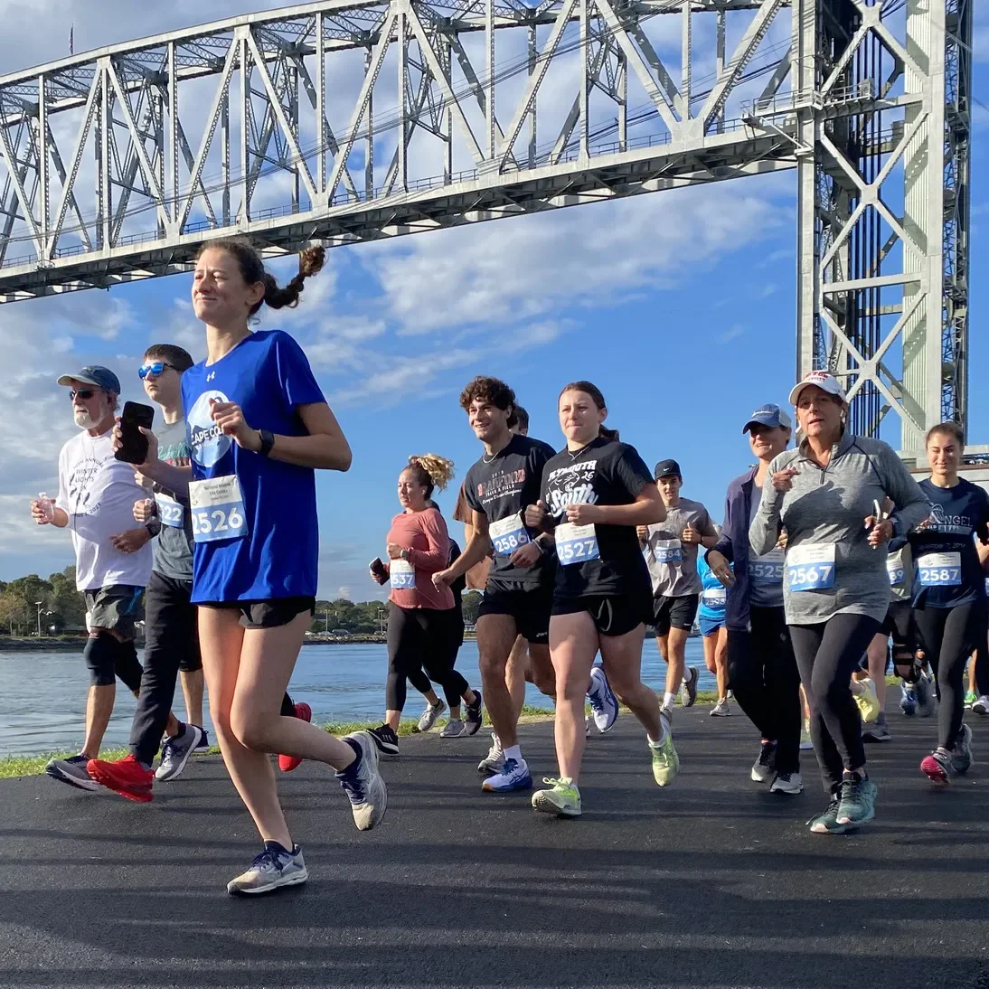Feet for Flippers 5k racers at the starting line under the Cape Cod Rail Road Bridge
